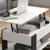 A white lift-top coffee table with storage, featuring a laptop, headphones, books, and a Marshall speaker. Voir les images du produit