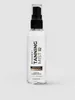A clear studio shot of a tanning mist bottle against a light gray background. Produktbild-Vorschau