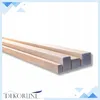 Several wooden beams of varying sizes are laid out diagonally on a white background. Anteprima dell’immagine prodotto