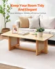 A living room scene with a coffee table in the foreground and a sofa in the background. Produktbild-Vorschau