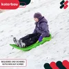 A child is sledding down a snowy hill on a green sled. Náhled obrázku produktu