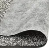 A close-up view of a layered material, likely a stone mat or similar product, showing the texture of the gravel and the fabric. Náhľad obrázku produktu