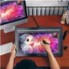 A person is using a pen display tablet to draw on a wooden desk, with a computer monitor in the background. Produktbild-Vorschau