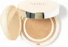 A cushion compact foundation with the lid open, showing the product inside. Voir les images du produit