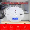 A carbon monoxide detector is shown on a wooden surface, with smoke effects and marketing text overlayed. Produktbild-Vorschau