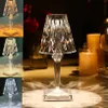 A collage of images showcasing a crystal LED table lamp in different lighting conditions and colors, with some images featuring candles and a blurred background. Produktbild-Vorschau
