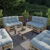 An outdoor patio setting with pallet furniture and plants. Voir les images du produit
