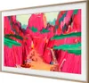A TV with a colorful landscape painting displayed on its screen, framed by a gold bezel. Voir les images du produit