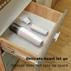 A small vacuum cleaner and its accessories are neatly stored in an open drawer. Produktbild-Vorschau