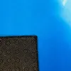 Close-up view of the corner of a rug, showing the textured underside and the blue surface. Produktbild-Vorschau
