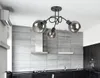 A modern kitchen with a sleek design, featuring a tiled backsplash, dark cabinets, and a contemporary chandelier. Produktbild-Vorschau