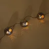 A string of decorative solar-powered lights with spherical, perforated casings. Produktbild-Vorschau