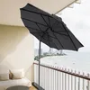 A balcony with a view of the sea and a city skyline, featuring a dark gray umbrella. Produktbild-Vorschau