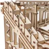 A close-up view of a wooden marble run construction kit with several silver marbles on its tracks. Podgląd zdjęcia produktu