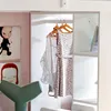 A child's bedroom with artwork and a closet with clothes hanging. Anteprima dell’immagine prodotto