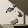 Three beige AirPods Pro cases are shown floating in front of a light beige background with a shadow cast from the right. Náhľad obrázku produktu