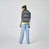 A young person wearing a backpack stands facing away from the camera against a white background. Produktbild-Vorschau