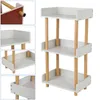 A white three-tiered shelf unit with wooden legs against a white background. Produktbild-Vorschau
