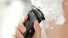A person is shaving their face with a Philips electric shaver, covered in shaving cream. Náhľad obrázku produktu