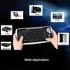 A hand holding a keyboard with various electronic devices shown around it, illustrating its wide application. Produktbild-Vorschau