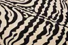 A close-up view of a rug with a zebra pattern. Produktbild-Vorschau