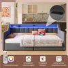 A modern bed with LED lighting and storage features, set in a bedroom with a kitchen in the background. Náhled obrázku produktu