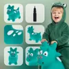 A child in a dinosaur costume is riding a green inflatable dinosaur toy. The image is a collage of different views of the toy and a pump. Podgląd zdjęcia produktu