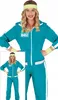 A woman wearing a teal tracksuit costume with yellow accessories. Produktbild-Vorschau