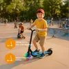 A young boy is riding an electric scooter in a skate park with other children in the background. Anteprima dell’immagine prodotto