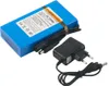 A blue rechargeable battery pack with a black power adapter and cables, shown on a white background. Produktbild-Vorschau