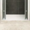 A shower enclosure with open doors, showing the white shower tray and dark tiled wall. Produktbild-Vorschau
