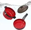 Three toy kitchen items submerged in water with bubbles. Anteprima dell’immagine prodotto