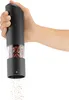 A hand holding an electric pepper grinder, grinding peppercorns. Produktbild-Vorschau