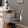 A modern home office setup with a white desk, a chair, and a lamp. Voir les images du produit