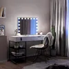 A vanity table with a lighted mirror, a chair, and a cactus plant in a room. Produktbild-Vorschau