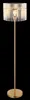 A floor lamp with a gold-colored metal base and stem, and a cylindrical shade made of clear glass rods. Náhľad obrázku produktu