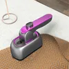 A handheld garment steamer sits on a textured fabric surface. Produktbild-Vorschau