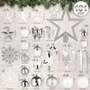 A collection of various Christmas ornaments arranged on a light gray and white background, with a hint of green pine branches at the top. Produktbild-Vorschau