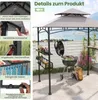 A grill pavilion with a barbecue and accessories set up on a patio with a view of a lake. Produktbild-Vorschau