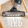 Close-up of a vacuum cleaner head with LED lights on a wooden floor. Produktbild-Vorschau