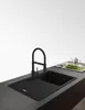 A black kitchen sink with a black faucet on a dark countertop. Anteprima dell’immagine prodotto