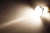 A close-up shot of a light bulb emitting a bright beam of light against a dark, textured background. Produktbild-Vorschau