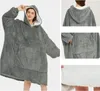 A collage of images showing a grey oversized hoodie blanket worn by a person and close-ups of its features. Náhľad obrázku produktu