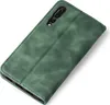 A green flip case for a smartphone, shown from a diagonal top-down view on a white background. Produktbild-Vorschau