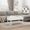 A living room scene with a sectional sofa and a white coffee table. Podgląd zdjęcia produktu