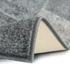 A close-up view of a rug, showing the texture and the edge where it is folded over. Produktbild-Vorschau