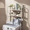 A shelving unit with various bathroom or laundry items next to a washing machine. Produktbild-Vorschau