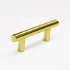 A gold cabinet handle is shown against a white background. Podgląd zdjęcia produktu