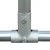 A close-up view of a galvanized steel pipe fitting, showing a T-joint connection with bolts. Náhľad obrázku produktu