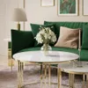 A living room scene with a green sofa, coffee table, and lamp. Produktbild-Vorschau